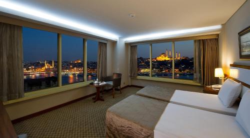 a hotel room with a bed and a large window at Istanbul Golden City Hotel in Istanbul