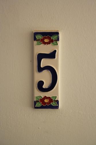 a number on a wall with flowers on it at Il Casalino in Maratea