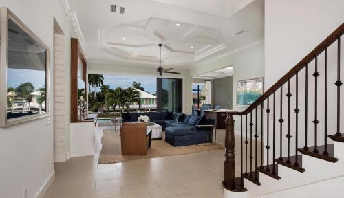 a living room with a staircase with a blue couch at Hollyhock in Marco Island