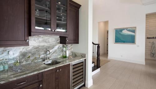 a kitchen with wooden cabinets and a sink at Hollyhock in Marco Island
