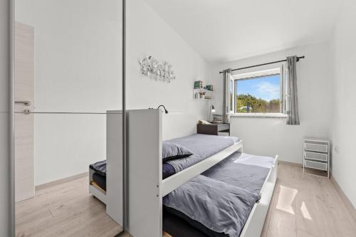 a bedroom with a bunk bed and a window at House Kacana in Vodnjan