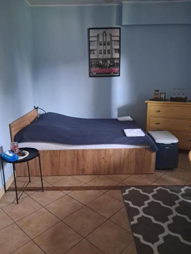 a bedroom with a bed and a table in a room at Cottage Room- Agroturystyka in Strzegowo-Osada