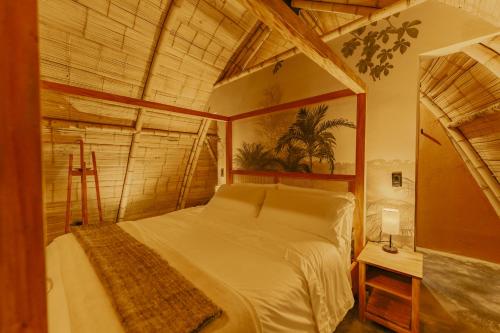 a bedroom with a large bed in a room at Hotel Casa Selvaggio in Ráquira