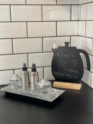 a black counter with three bottles on a tray at Casa Posidonia in Korinthos