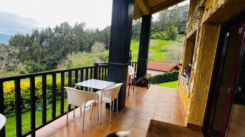 a balcony with a table and chairs on it at Casa Simona in Villaviciosa