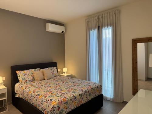 a bedroom with a bed and a window at Dimora degli Ulivi in Rimini