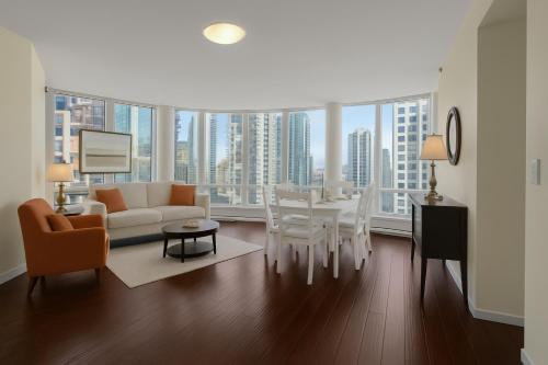 a living room with a white couch and a table at Luxury 3BR Apartment In The Heart Of Downtown - Gorgeous Views! in Vancouver