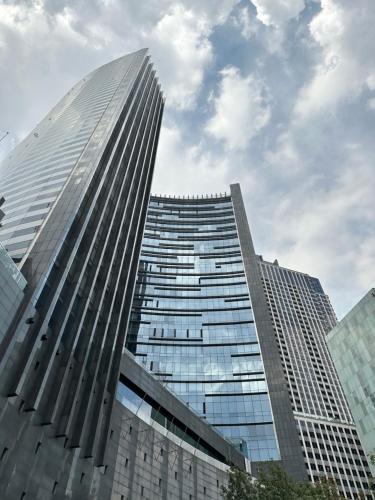 a tall building with many windows in a city at Residencias Plaza in Mexico City