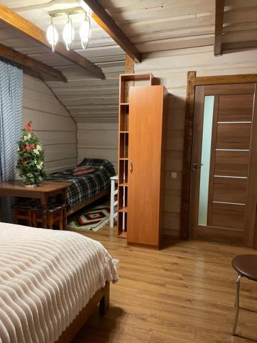 a bedroom with a bed and a desk and a table at Pidkova in Verkhovyna