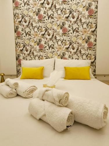 a bedroom with a bed with towels on it at Petra in Pietrelcina