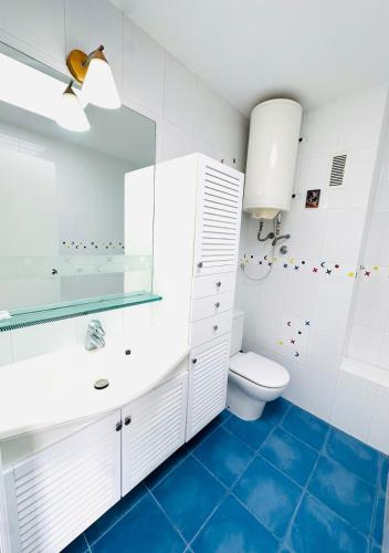 a bathroom with a toilet and a sink at Prime Location Penthouse with Stunning Sea Views in Salou