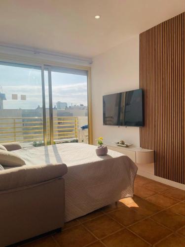 a bedroom with a large bed and a large window at Prime Location Penthouse with Stunning Sea Views in Salou