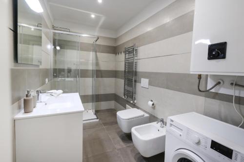 a bathroom with a sink and a washing machine at Alma Home Experience in Ventimiglia