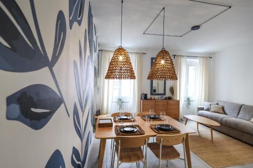 a living room with a table and a couch at Alma Home Experience in Ventimiglia