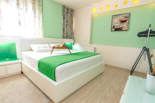 a bedroom with a bed with a table on it at Turquoise Front Sea Apartment in Kokkíni Khánion