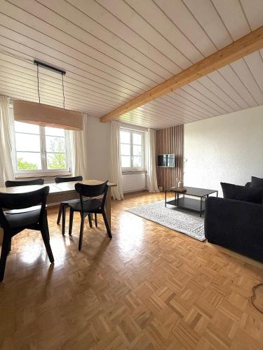 a living room with a couch and a table at Apartment in Bolligen in Bolligen