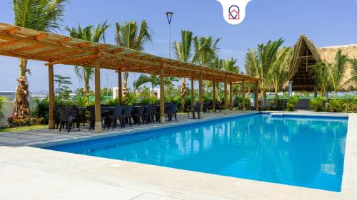 a pool at a resort with a table and chairs at Beautiful Apartment in Dream Acapulco Diamante in Acapulco
