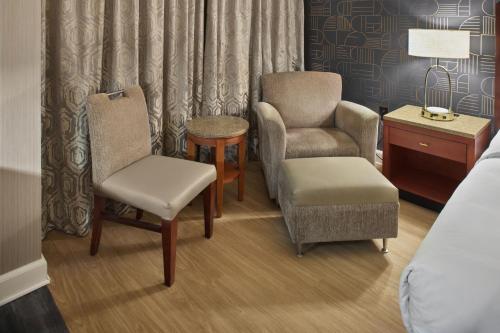 a hotel room with a bed and a chair and a table at DoubleTree by Hilton Akron Fairlawn in Fairlawn