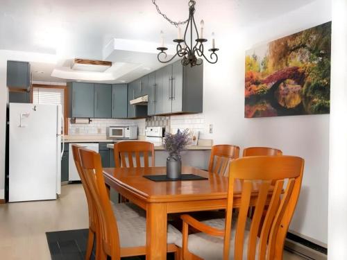 a kitchen with a dining room table and chairs at Mountains Getaway in Campton