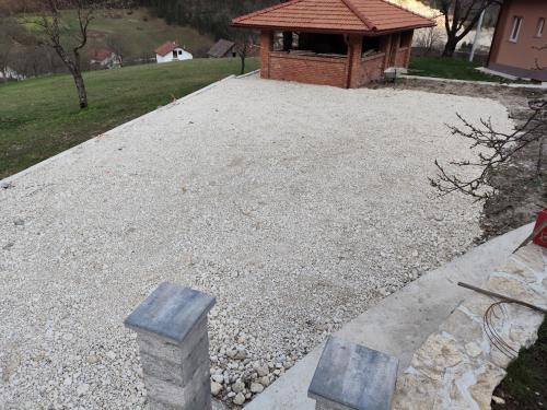 a gravel yard with a building in the background at Oaza mira Šipovo in Šipovo