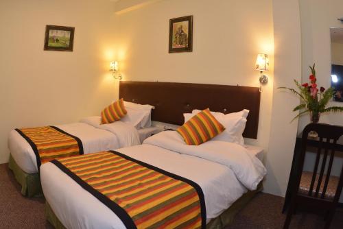 a hotel room with two beds in a room at Hotel Serenity in Kathmandu