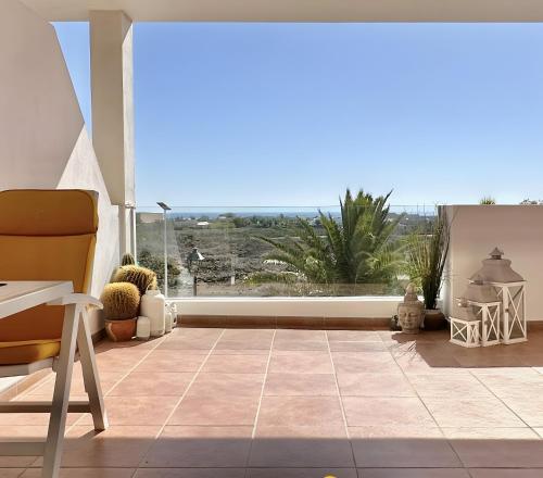 a living room with a view of a patio at Casa Rosa in Costa Teguise