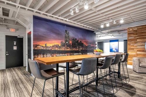 a conference room with a long table and chairs at Skyline Suite with Penthouse & Rooftop Deck 6BR by Maddox Hotel in Nashville