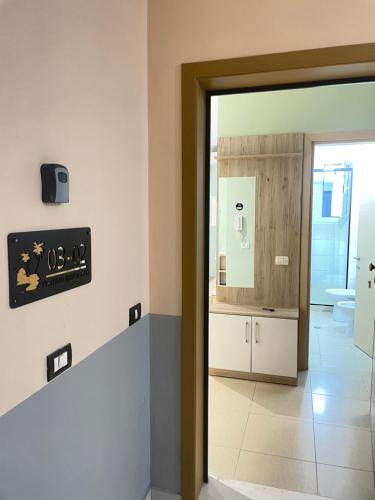 a bathroom with a sink and a toilet and a mirror at Premium Apartaments 02-03 in Vlorë