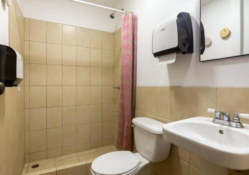 a bathroom with a toilet and a sink at Socialtel Antigua in Antigua Guatemala