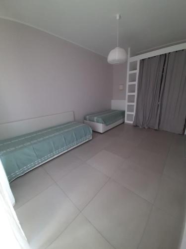 a room with two beds and a staircase in it at Le case di Lucanna in Rapallo