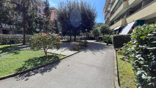 a walkway through a courtyard with flowers and trees at Le case di Lucanna in Rapallo