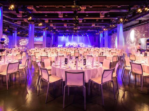 a set up for a banquet with white tables and chairs at Vienna House by Wyndham Andel's Berlin in Berlin