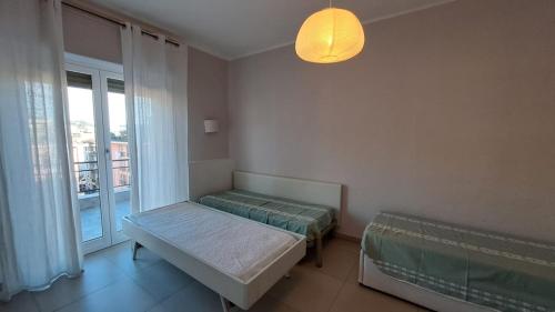 a bedroom with two beds and a window at Le case di Lucanna in Rapallo