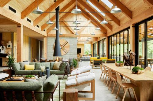 an open living room with wooden ceilings and furniture at AutoCamp Catskills in Saugerties