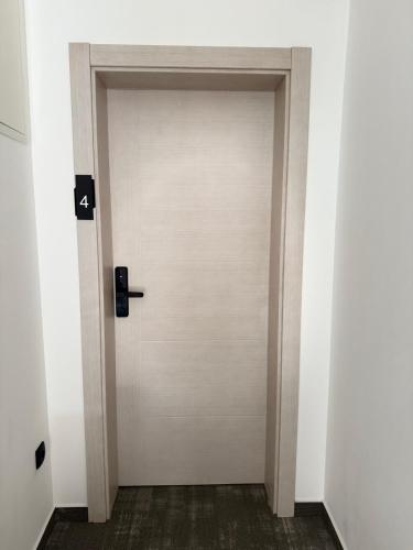 a door with the number four on it in a room at Apartments & Rooms Villa Zaad FREE PRIVATE PARKING in Mostar