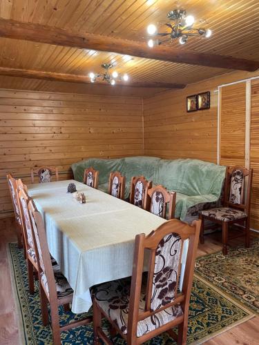 a dining room with a table and a couch at Pidkova in Verkhovyna
