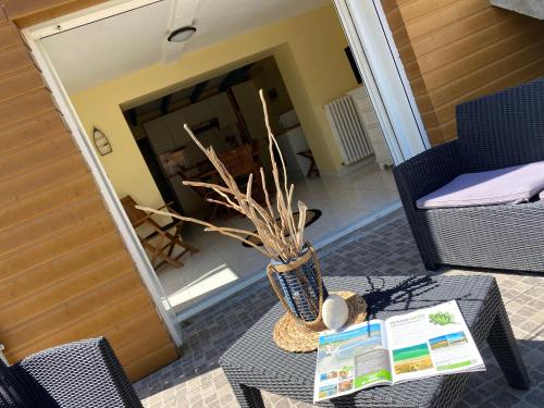 a vase sitting on a table in a living room at Brise des dunes in Saint-Pierre-dʼOléron