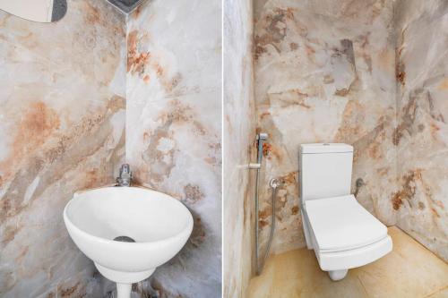 a bathroom with a toilet and a sink at Paradise Living in Bangalore