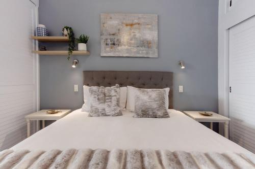 a bedroom with a bed with white sheets and pillows at Spacious Newly Renovated Princes Wharf 1BR in Auckland