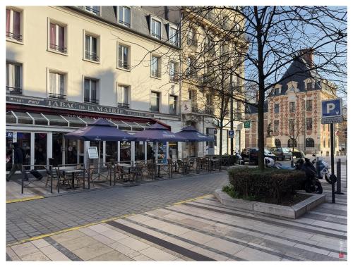 une rue avec des tables et des parasols sur une rue de la ville dans l'établissement 4 pièces avec terrasse- 1 min du métro - Paris, à Charenton-le-Pont