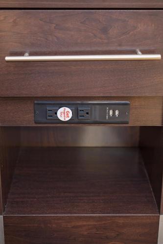a drawer in a wooden cabinet with a sticker on it at Red Roof Inn Georgetown, IN - Louisville West in Georgetown