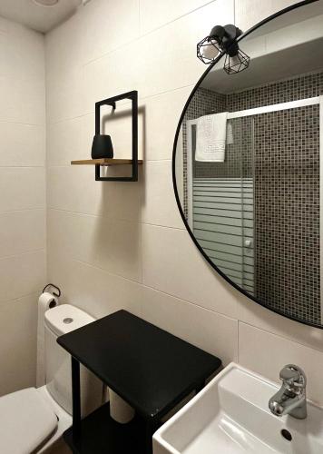 a bathroom with a mirror and a sink and a toilet at Luna de Borobia in Borobia