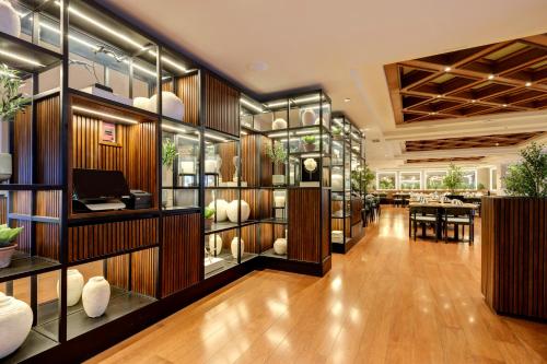 a lobby with glass shelves and a dining room at Plaza El Bosque Ebro in Santiago