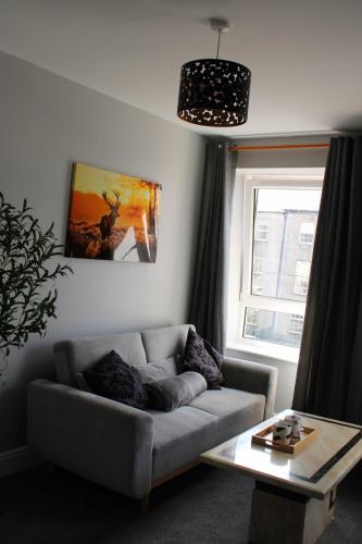 a living room with a couch and a table at Stylish Apartment in Tralee in Tralee