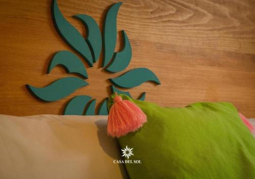 a painting of a green bird on a wall at Hotel Casa del Sol in San Cristóbal de Las Casas