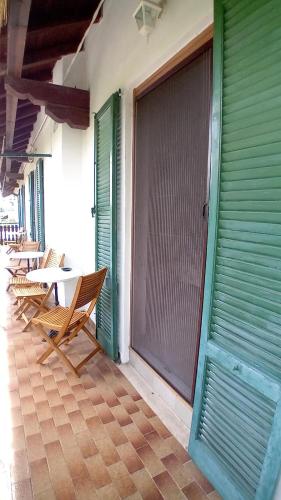 a patio with chairs and a table and a window at Il Casolare del Medio Olona in Fagnano Olona