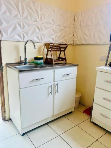 a kitchen with white cabinets and a sink at Apartamento SamSay III in San Isidro