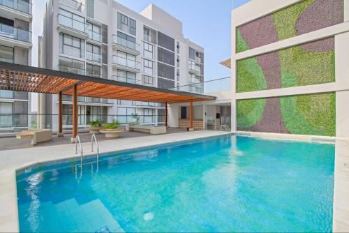 a swimming pool in front of a building at Comfortable apartment near the beach in Playa Bello Horizonte