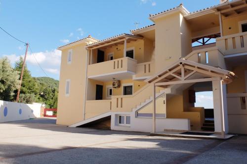 a building with a staircase in a parking lot at Agrabeli Apartments in Limne