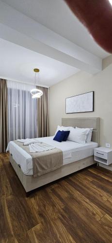 a bedroom with a large bed in a room at Bahr DELUX App & Suite in Ulcinj